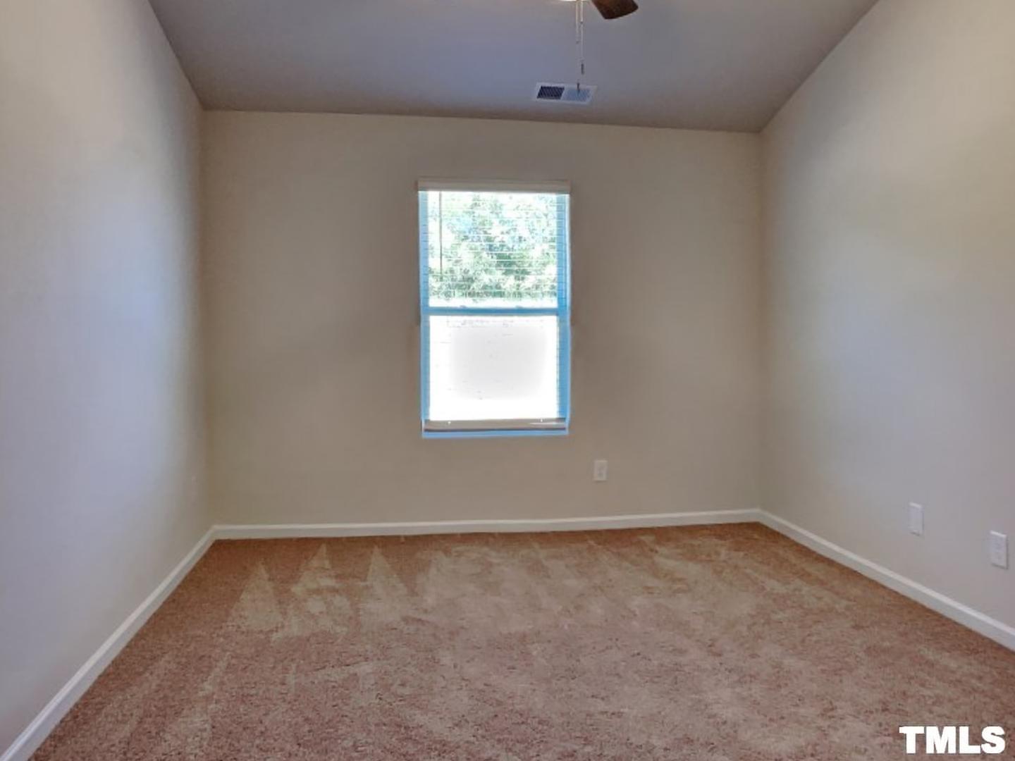 175 Coleshill Road Angier, NC 27501 - Photo 8 of 16 an empty room with a window