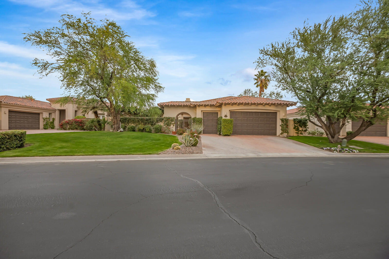 128 Loch Lomond Road Rancho Mirage, CA 92270 - Photo 1 of 42 a white house with a large tree in front of it