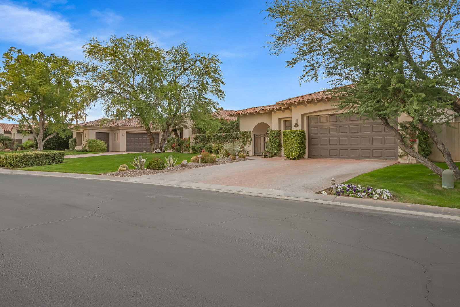 128 Loch Lomond Road Rancho Mirage, CA 92270 - Photo 2 of 42 a front view of a house with a yard and garage
