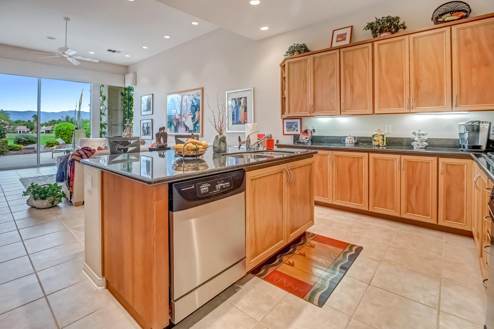 128 Loch Lomond Road Rancho Mirage, CA 92270 - Photo 11 of 42 a kitchen with stainless steel appliances granite countertop a sink stove and cabinets