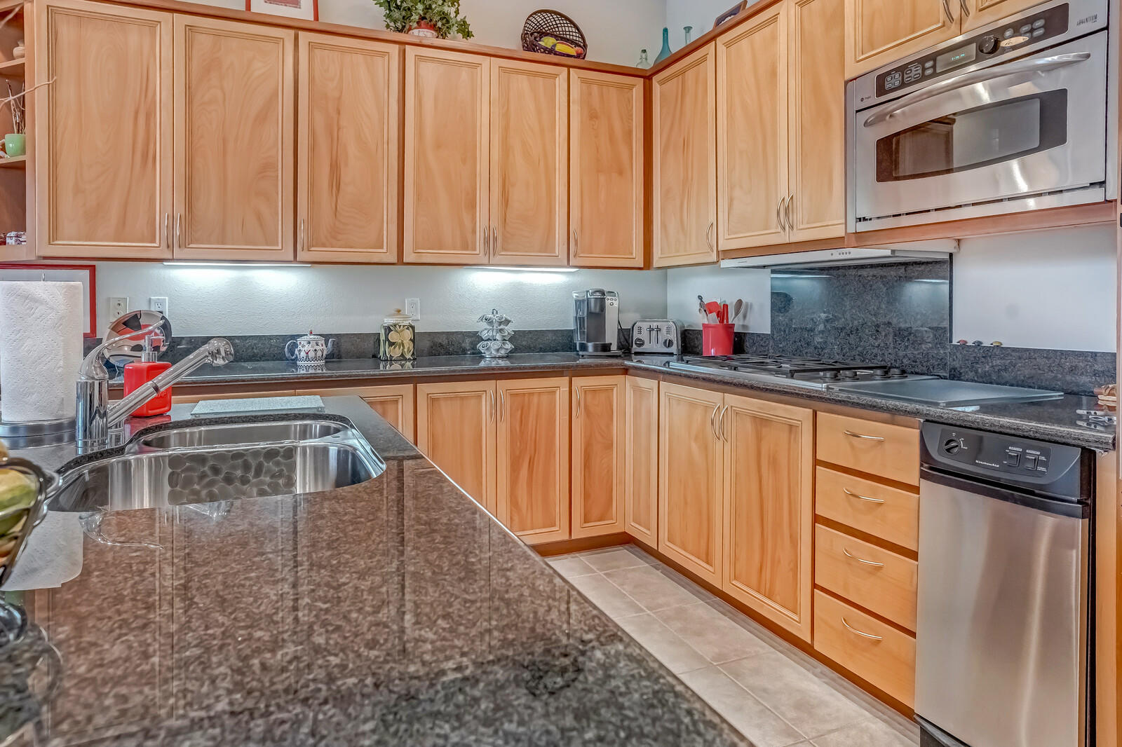 128 Loch Lomond Road Rancho Mirage, CA 92270 - Photo 12 of 42 a kitchen with stainless steel appliances granite countertop a sink stove and cabinets