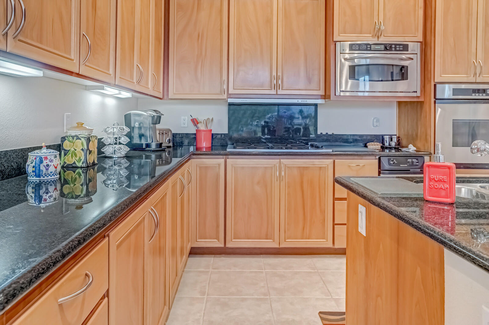128 Loch Lomond Road Rancho Mirage, CA 92270 - Photo 13 of 42 a kitchen with granite countertop a sink and cabinets