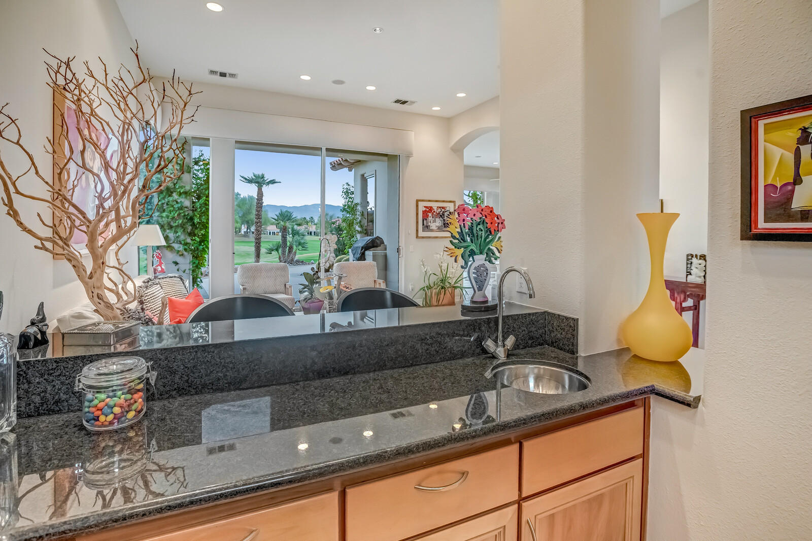 128 Loch Lomond Road Rancho Mirage, CA 92270 - Photo 18 of 42 a living room with granite countertop kitchen island stainless steel appliances a sink and a counter top space