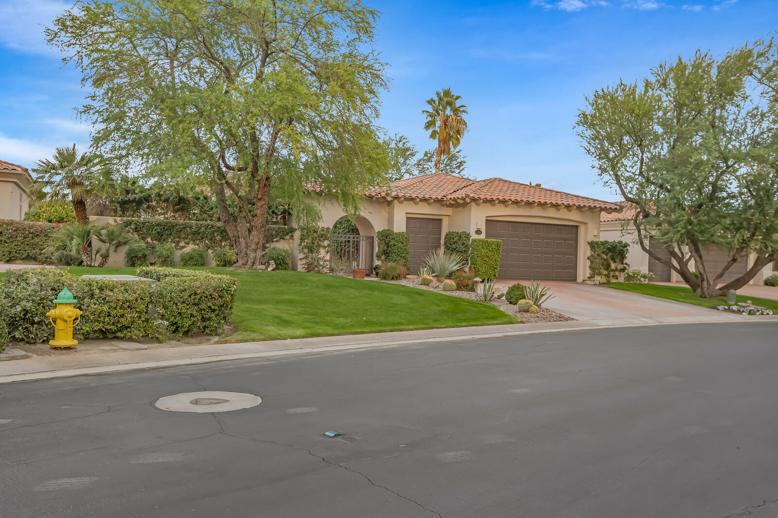 128 Loch Lomond Road Rancho Mirage, CA 92270 - Photo 3 of 42 a front view of a house with a yard and garage