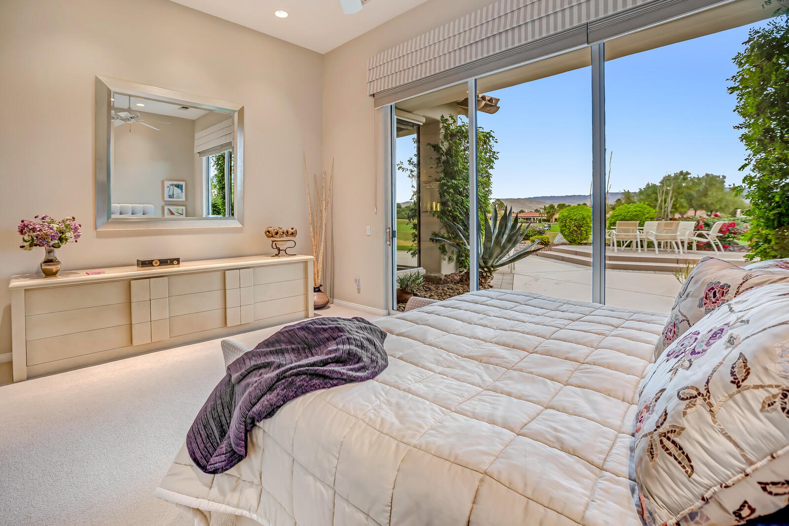 128 Loch Lomond Road Rancho Mirage, CA 92270 - Photo 22 of 42 a bed sitting in a bedroom next to a large window