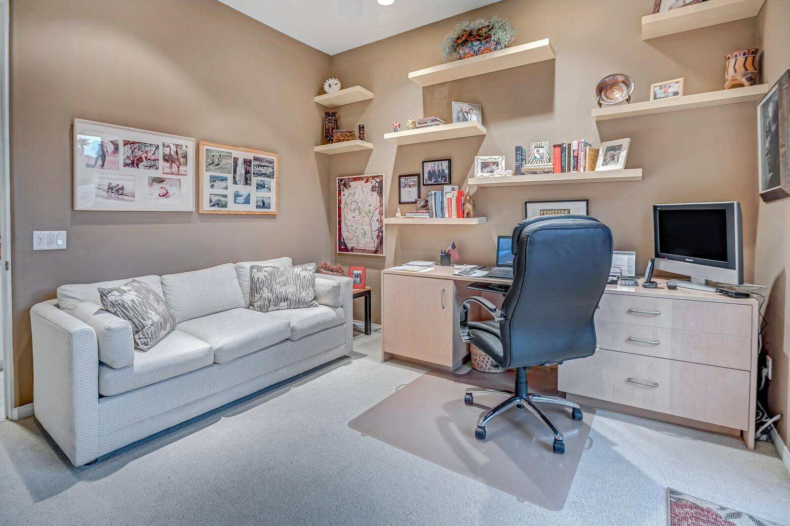128 Loch Lomond Road Rancho Mirage, CA 92270 - Photo 33 of 42 a view of a livingroom with workspace and a couch