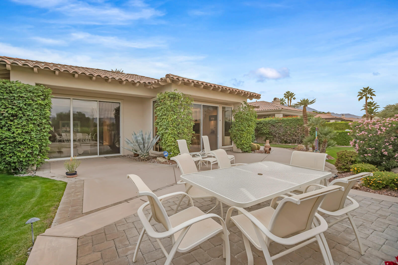 128 Loch Lomond Road Rancho Mirage, CA 92270 - Photo 40 of 42 a view of a patio with table and chairs and potted plants