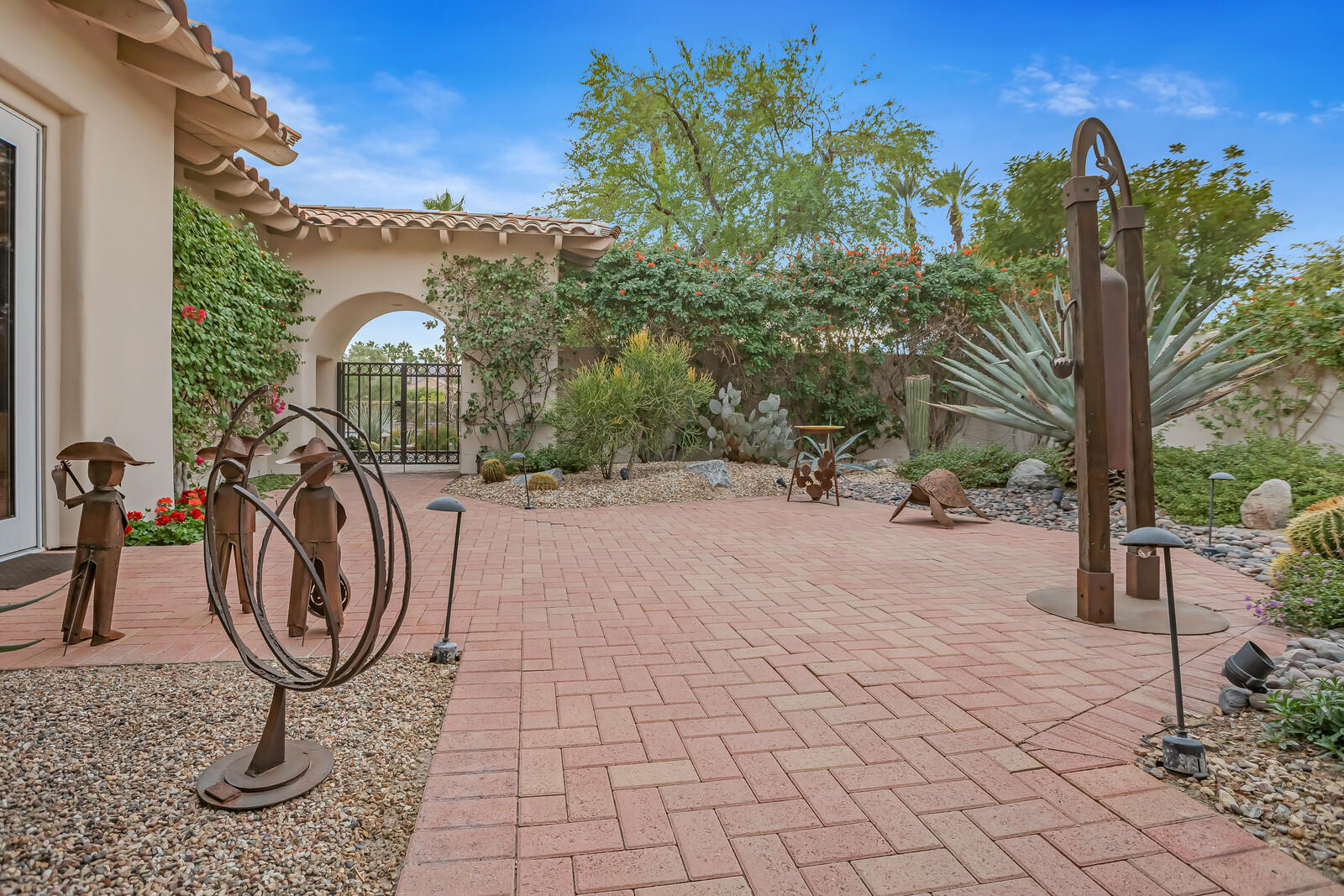 128 Loch Lomond Road Rancho Mirage, CA 92270 - Photo 5 of 42 a view of a backyard with plants and a fountain
