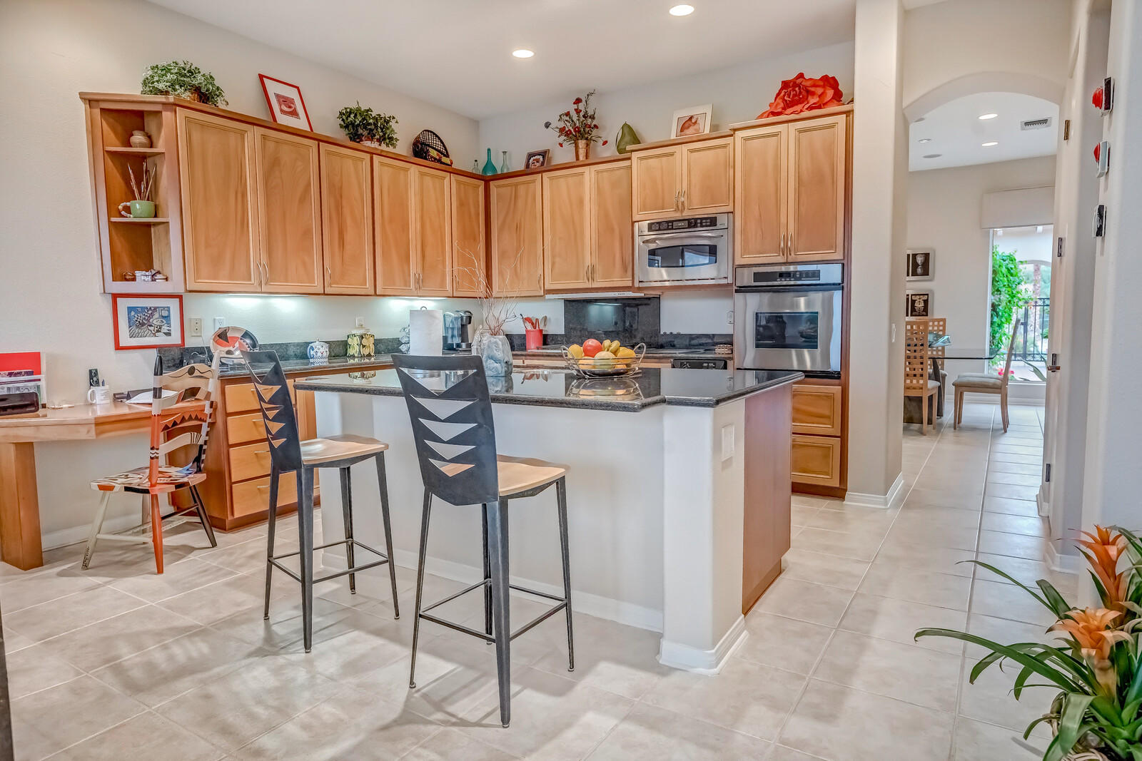 128 Loch Lomond Road Rancho Mirage, CA 92270 - Photo 10 of 42 a kitchen that has a lot of cabinets in it and appliances