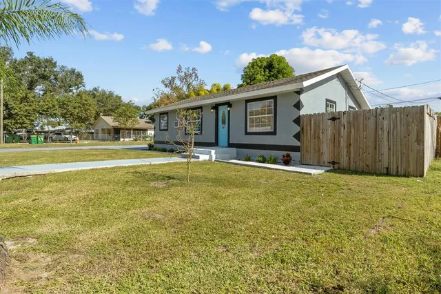 a house view with swimming pool and wooden fence