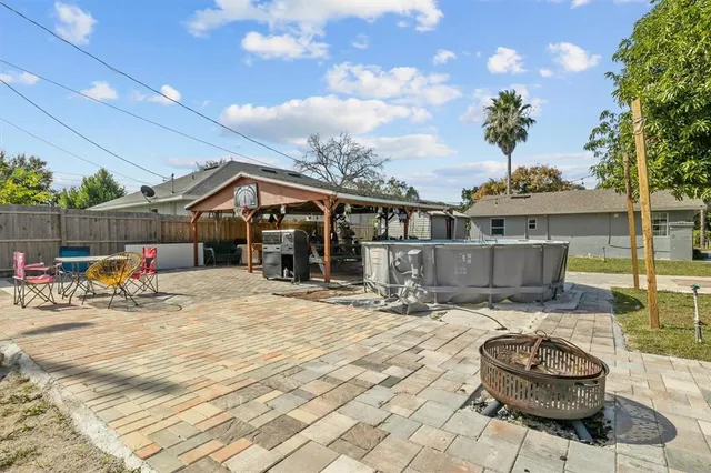 a house view with swimming pool and trees in the background