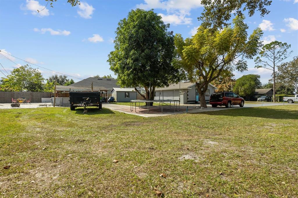 513 5th Street South Dundee, FL 33838 - Photo 28 of 29 a house view with swimming pool and trees