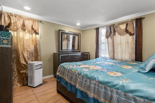 a bedroom with a bed next to a window with the outer view