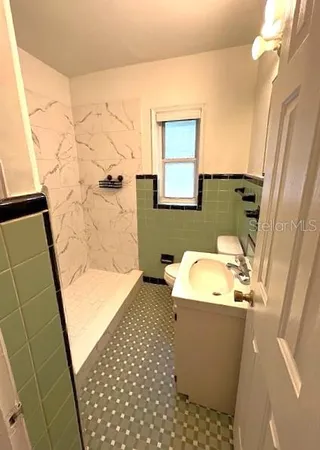 a bathroom with sink toilet and shower