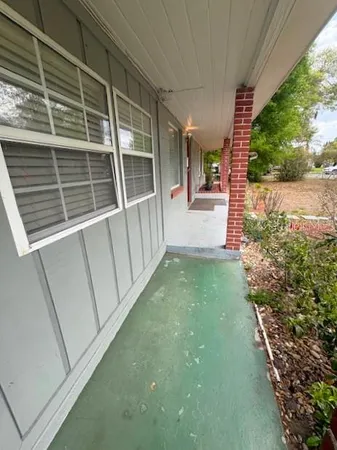 a view of a house with a yard and tree s