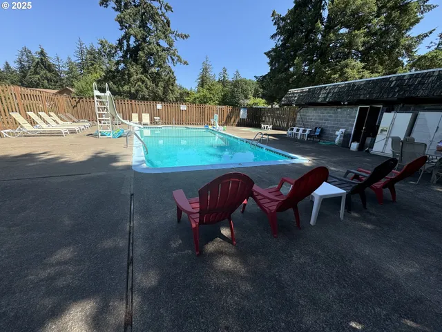 a backyard of a house with table and chairs