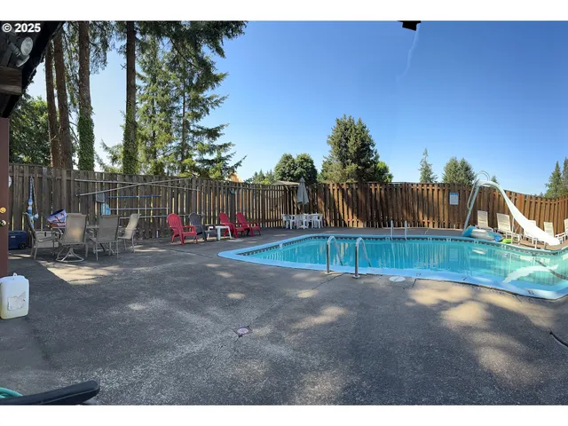 a view of a backyard with wooden fence