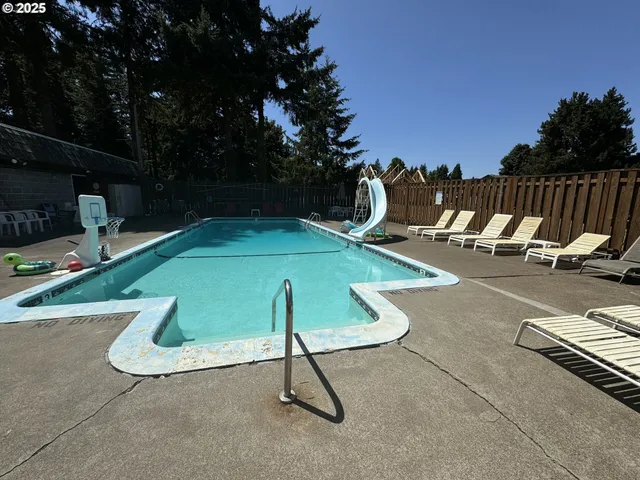 a view of a swimming pool with sitting area