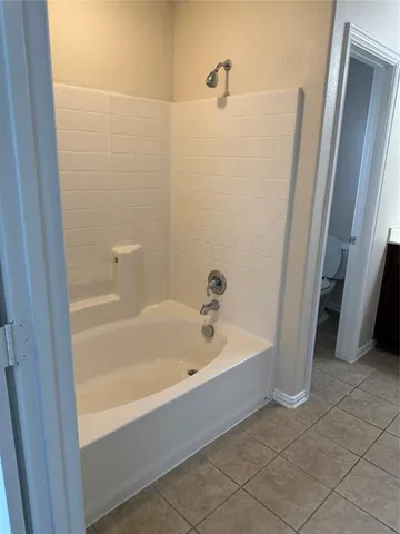 a spacious bathroom with a bathtub and a shower