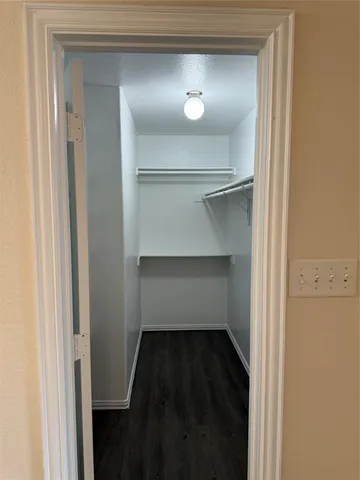 a view of walk in closet with empty racks