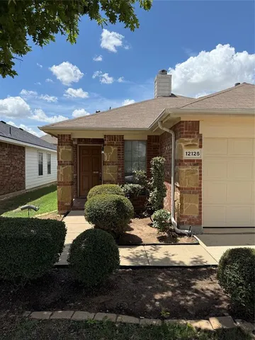 a view of a house with yard and sitting area