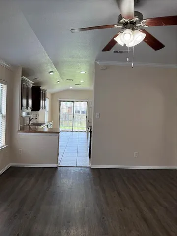 a view of kitchen with refrigerator and wooden floor