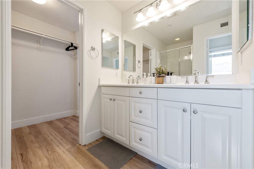 94 Chantilly Irvine, CA 92620 - Photo 16 of 30 a bathroom with a double vanity sink and mirror