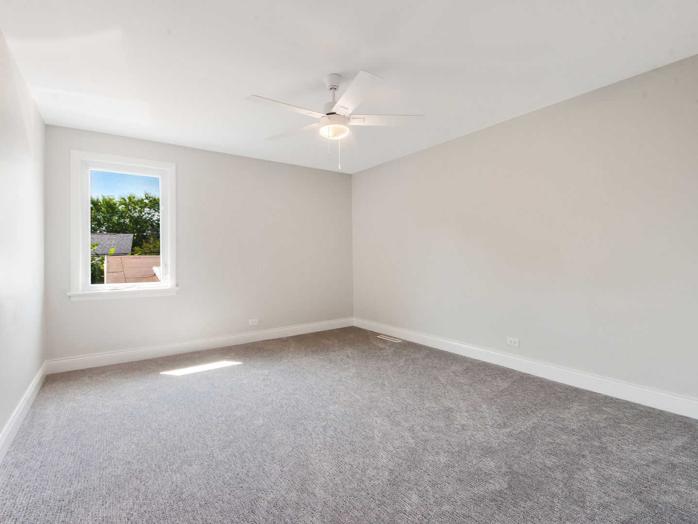 4343 Davis Street Skokie, IL 60076 - Photo 29 of 41 an empty room with a chandelier fan and windows