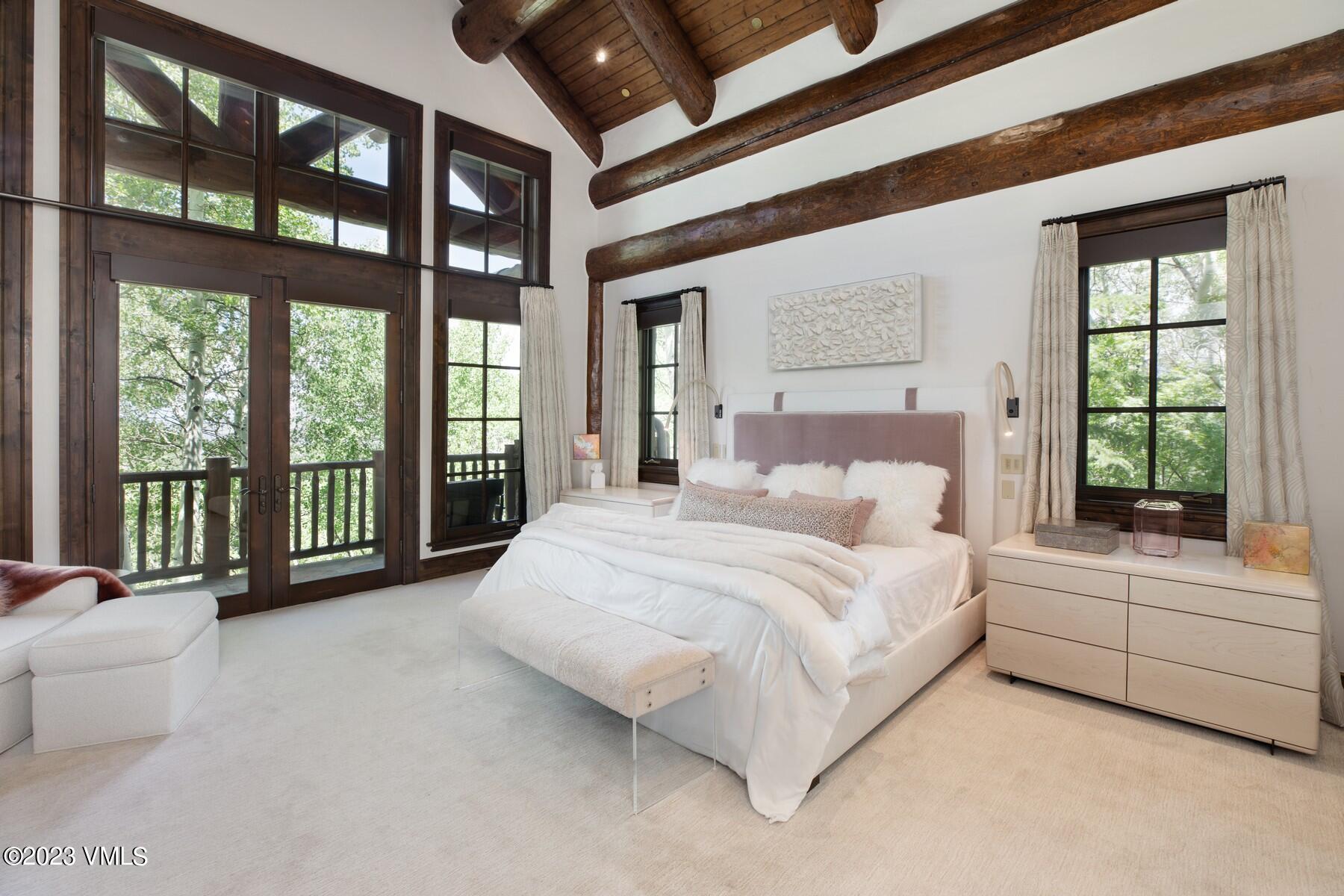 941 Daybreak Ridge Road Avon, CO 81620 - Photo 13 of 29 a spacious bedroom with a large bed and a large window