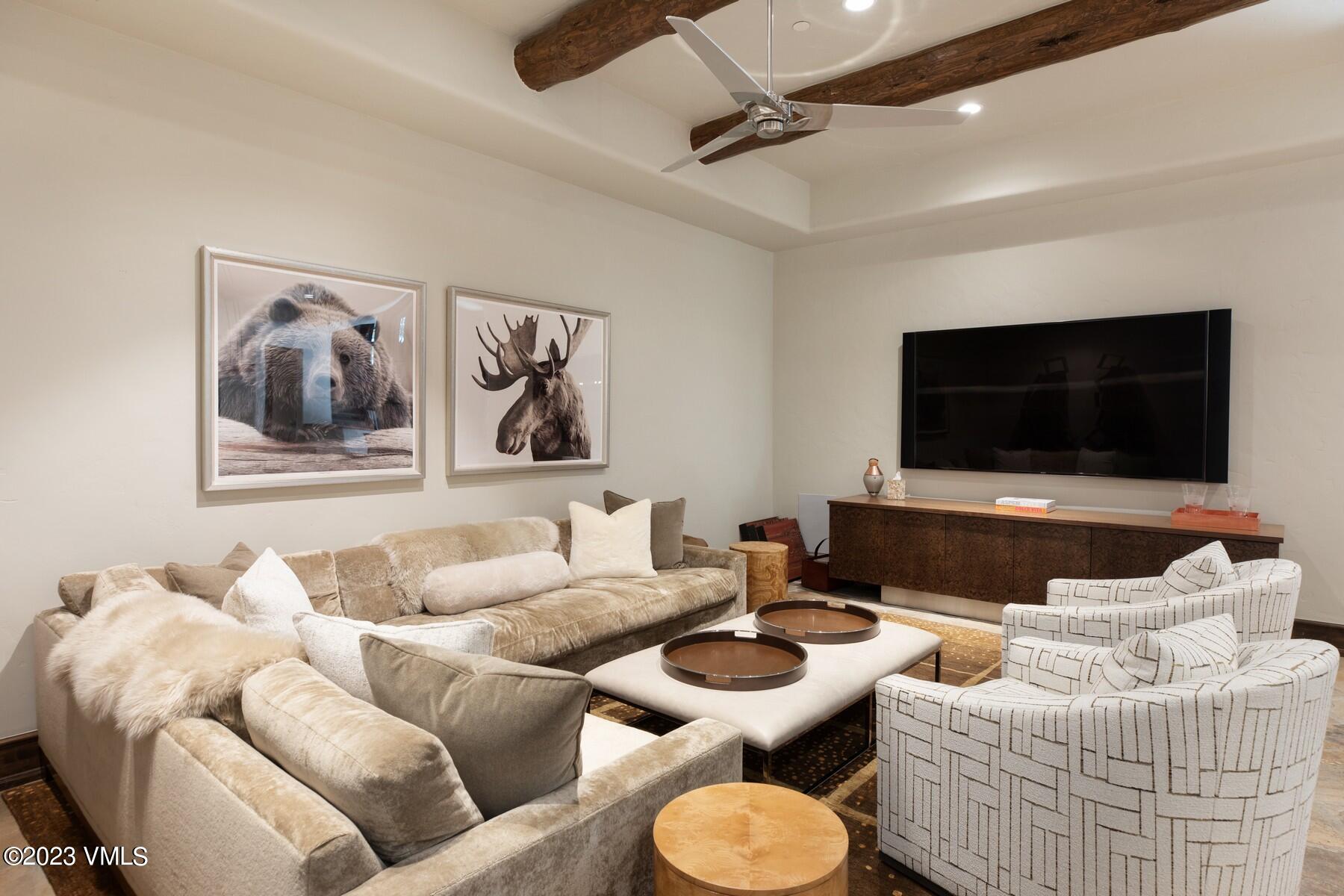 941 Daybreak Ridge Road Avon, CO 81620 - Photo 21 of 29 a living room with furniture and a flat screen tv