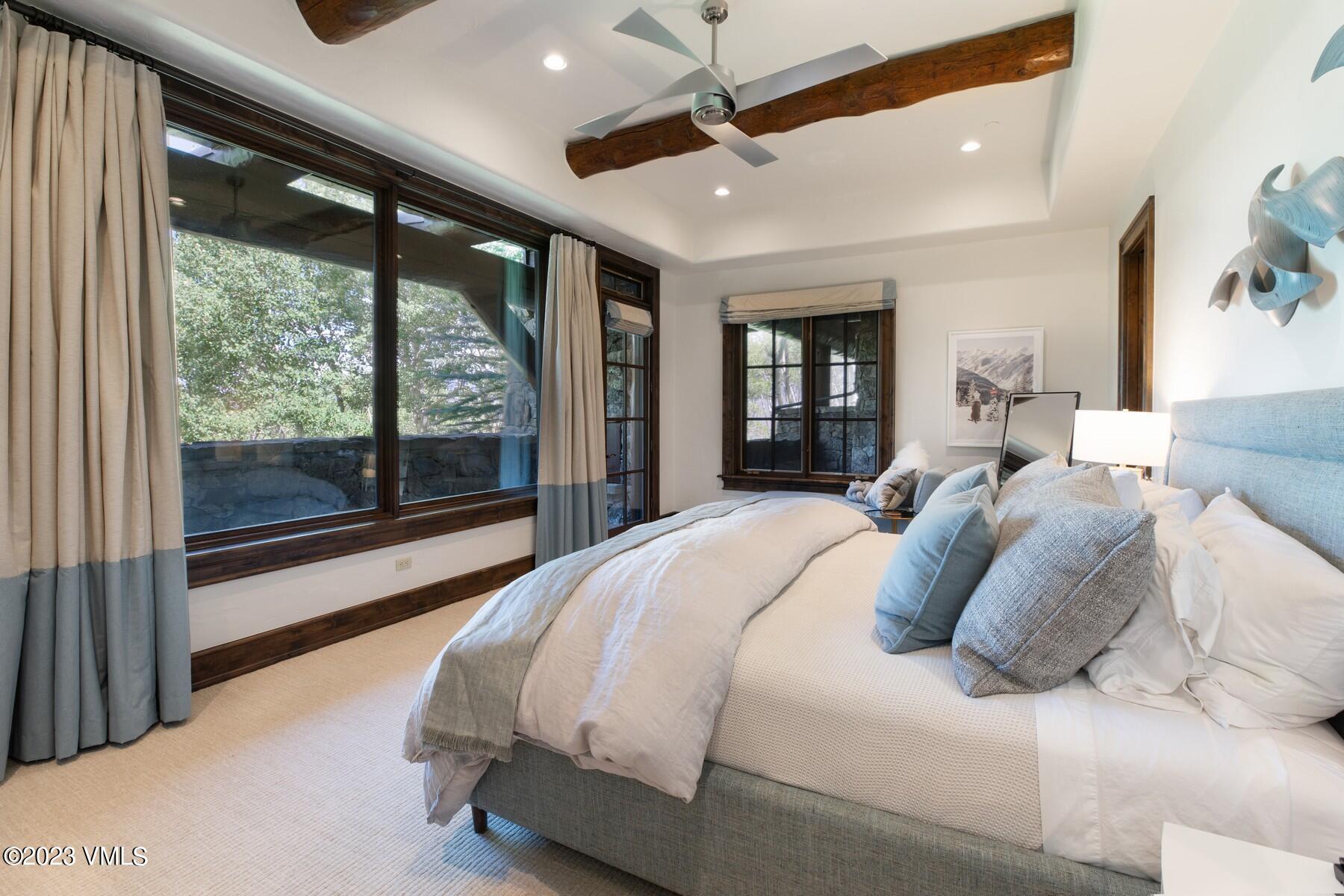 941 Daybreak Ridge Road Avon, CO 81620 - Photo 22 of 29 a bedroom with a large bed and a large window