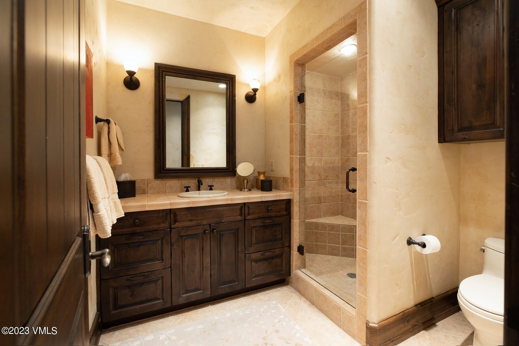 941 Daybreak Ridge Road Avon, CO 81620 - Photo 23 of 29 a bathroom with a double vanity sink mirror double and shower