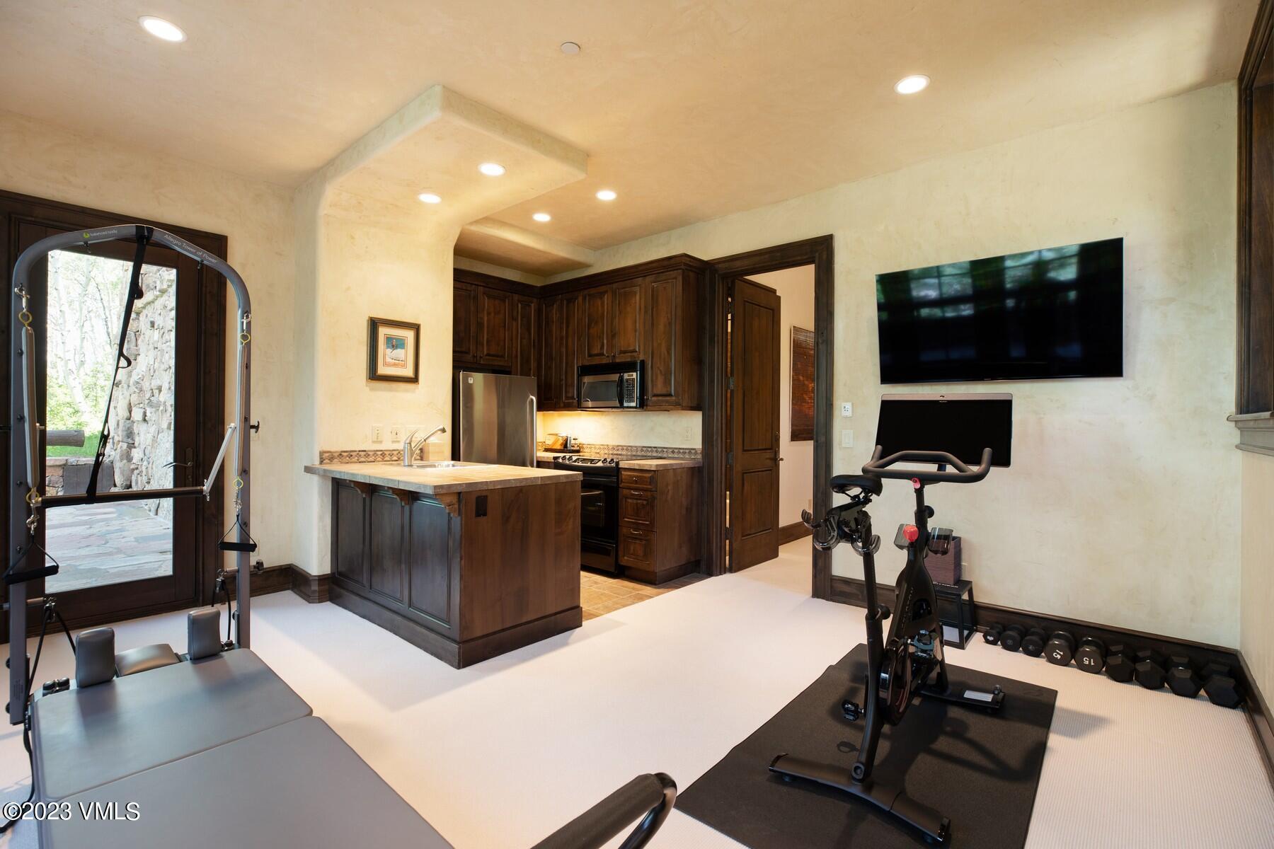 941 Daybreak Ridge Road Avon, CO 81620 - Photo 27 of 29 a kitchen with a refrigerator and a stove top oven