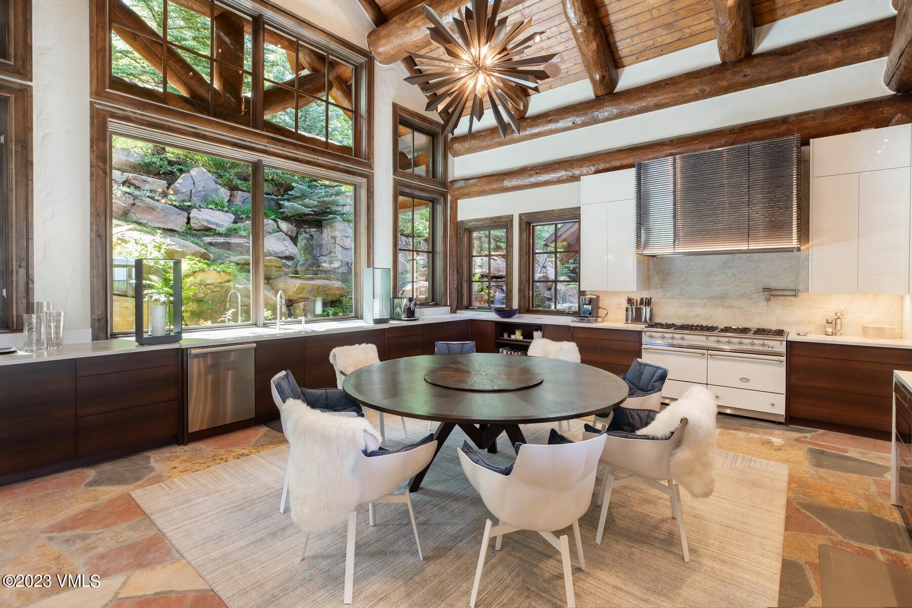 941 Daybreak Ridge Road Avon, CO 81620 - Photo 3 of 29 a dining room with a large window table and chairs