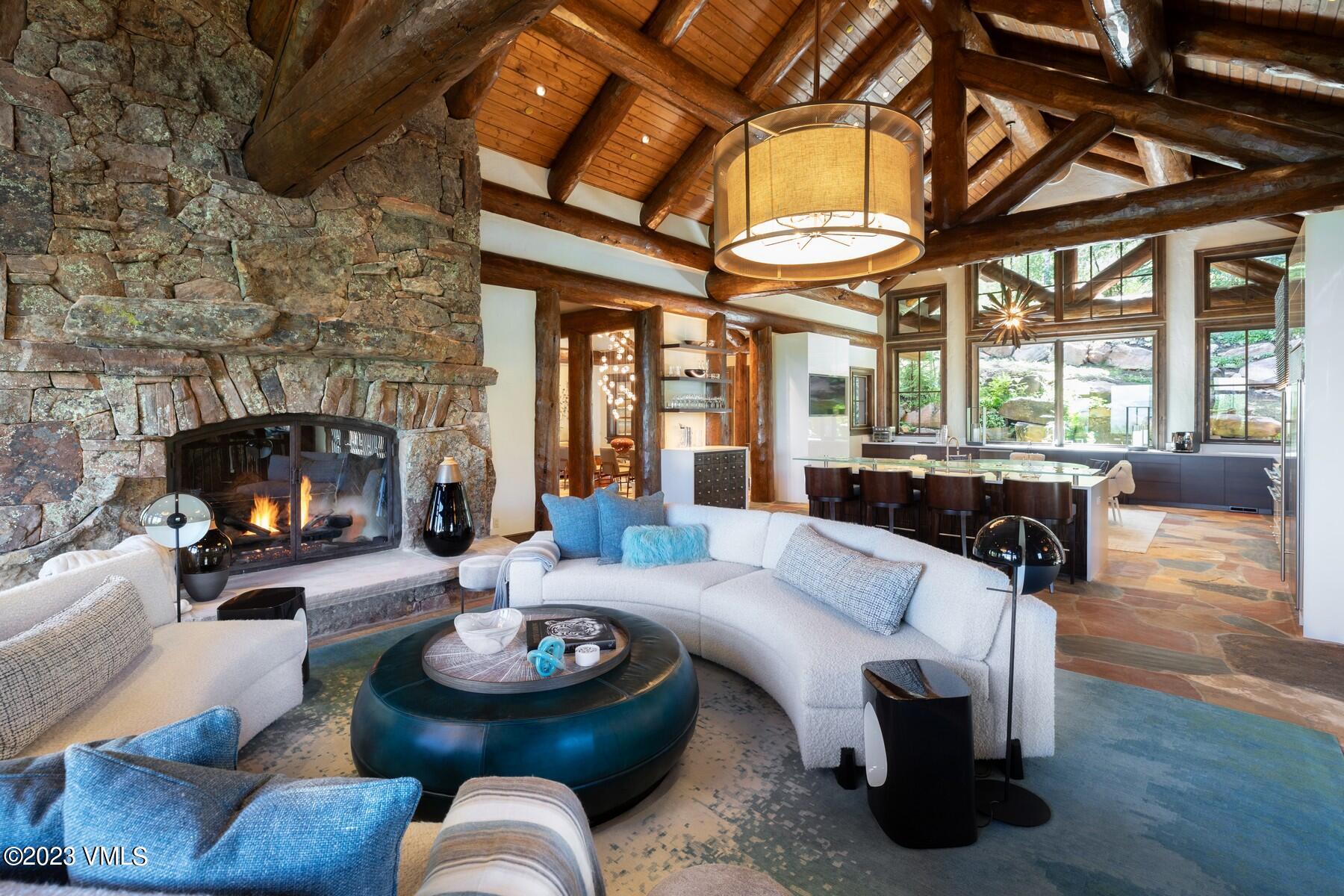 941 Daybreak Ridge Road Avon, CO 81620 - Photo 7 of 29 a living room with furniture a fireplace and a large window