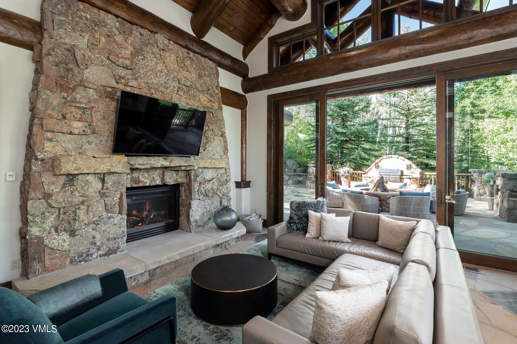 941 Daybreak Ridge Road Avon, CO 81620 - Photo 9 of 29 a living room with furniture a fireplace and a flat screen tv