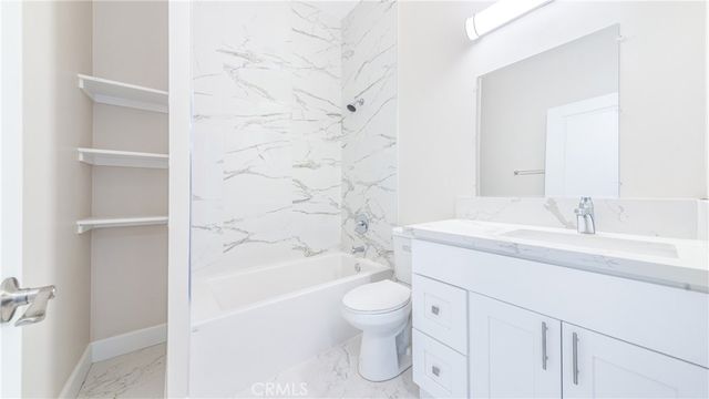 a bathroom with a sink toilet vanity and bathtub