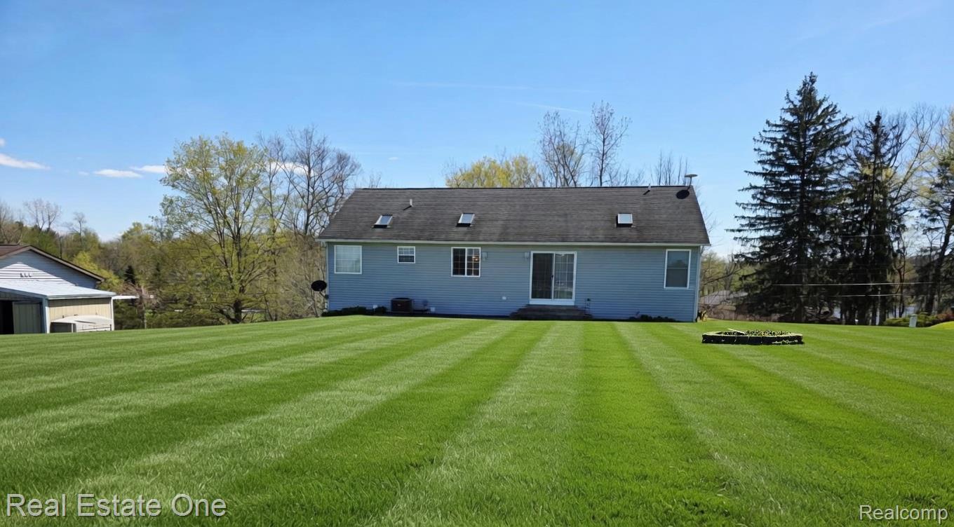 8751 Highland Road Watervliet, MI 49098 - Photo 6 of 16 Rear view of property with a yard