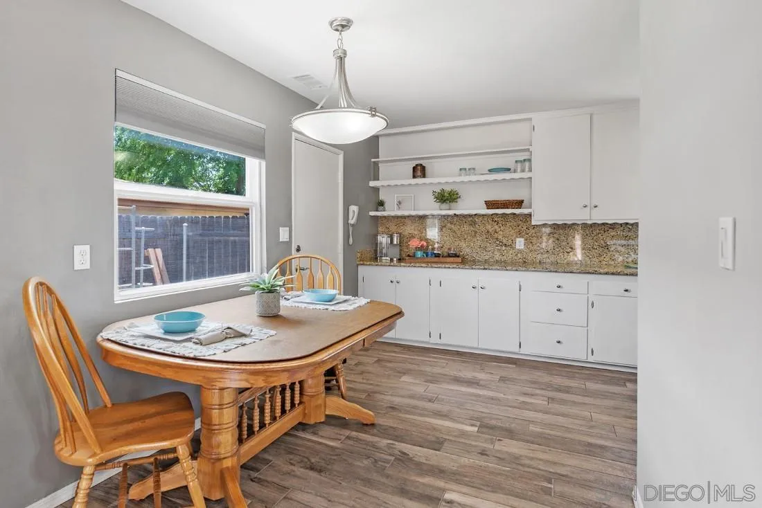 13829 Tobiasson Road Poway, CA 92064 - Photo 15 of 52 a dining room with furniture a chandelier and wooden floor