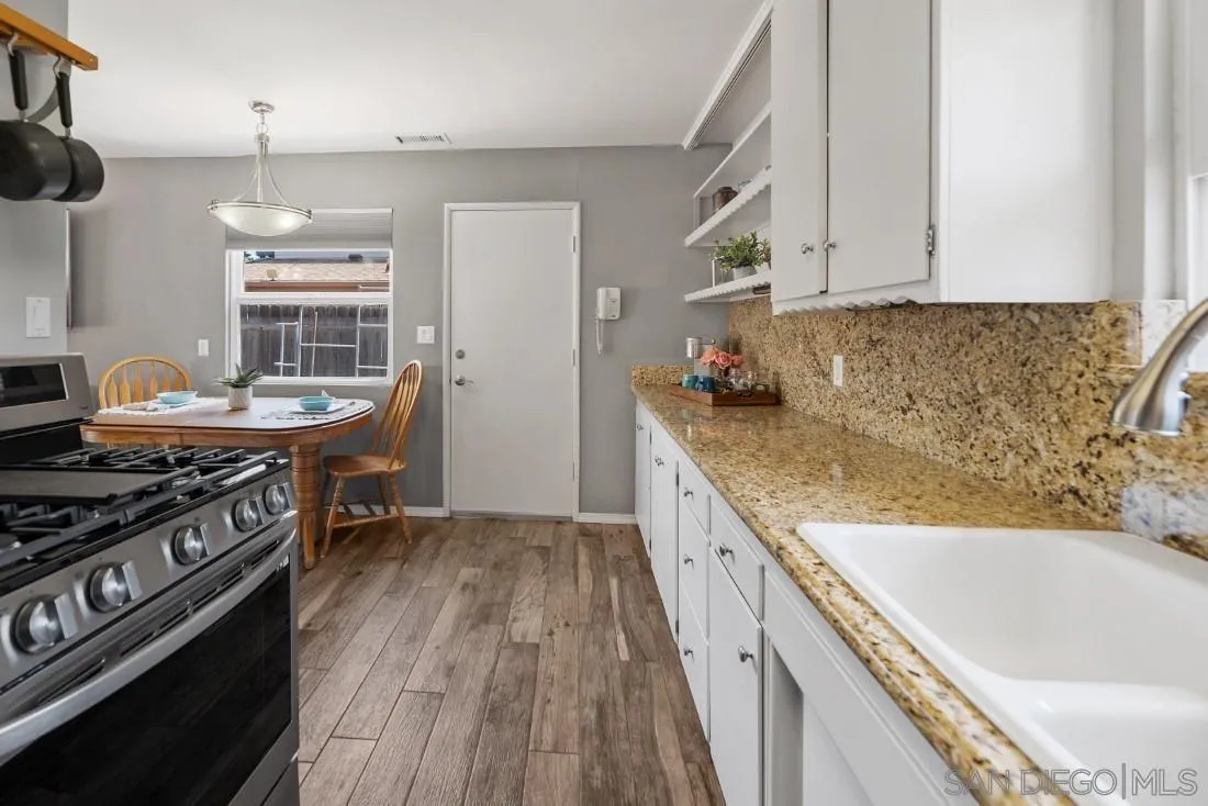 13829 Tobiasson Road Poway, CA 92064 - Photo 18 of 52 a kitchen with stainless steel appliances granite countertop a sink stove and refrigerator
