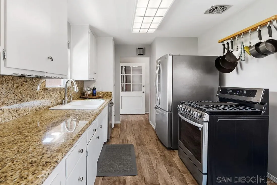 13829 Tobiasson Road Poway, CA 92064 - Photo 20 of 52 a kitchen with stainless steel appliances granite countertop a stove and a refrigerator