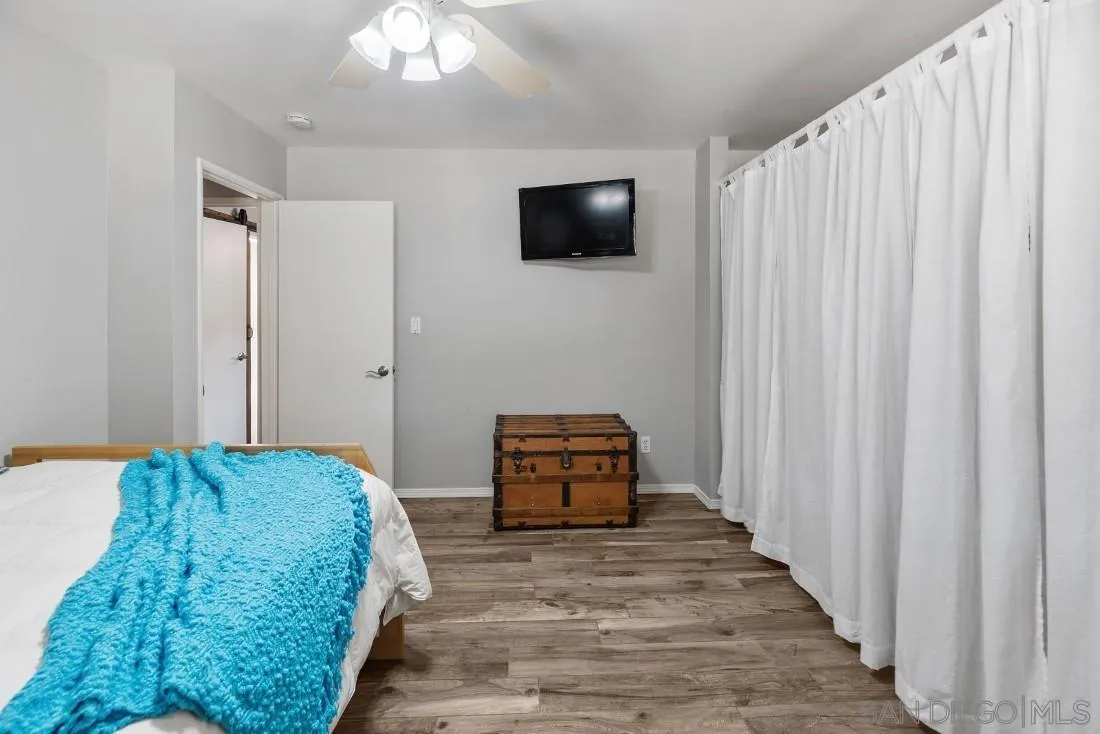 13829 Tobiasson Road Poway, CA 92064 - Photo 27 of 52 a bedroom with a bed and a flat screen tv