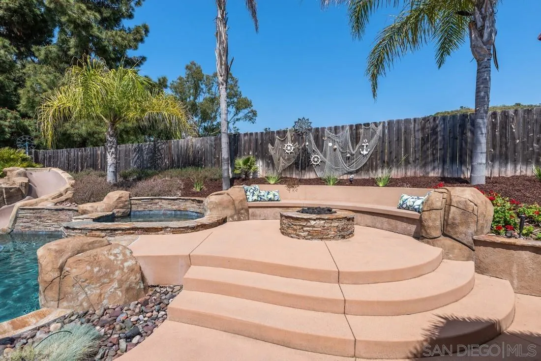 13829 Tobiasson Road Poway, CA 92064 - Photo 45 of 52 a view of a backyard with couches and a fire pit