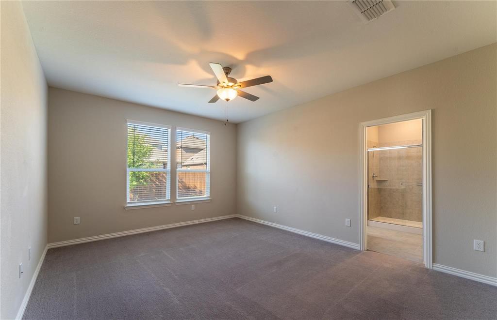 2020 Robert Street Anna, TX 75409 - Photo 11 of 16 an empty room with chandelier fan and windows
