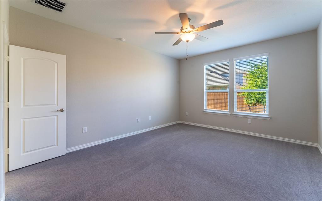 2020 Robert Street Anna, TX 75409 - Photo 12 of 16 an empty room with windows and fan