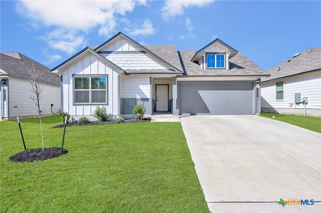 a front view of a house with a yard and garage