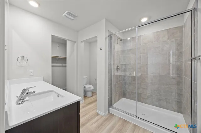 a bathroom with a shower sink and mirror