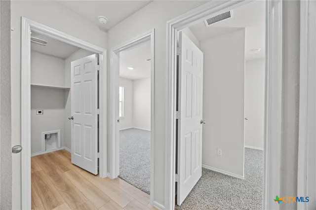 a view of hallway with wooden floor