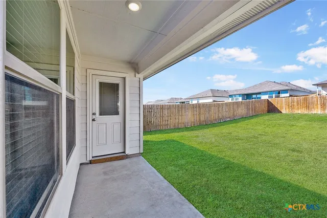 a view of yard with swimming pool and green space