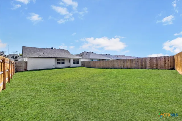 an aerial view of a house with a swimming pool